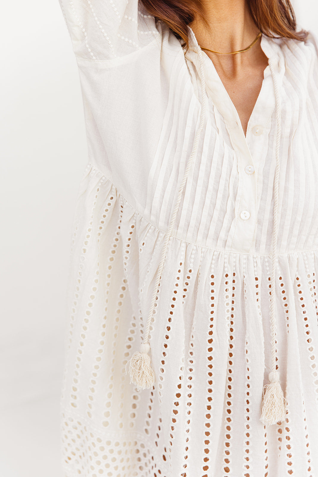 White dress with intricate detailing on a plain background