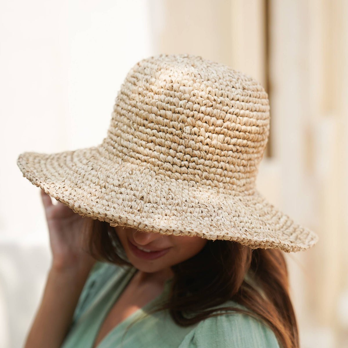 Person wearing a straw hat with a blurred background